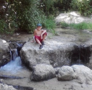 Prince Alex sitting at the falls