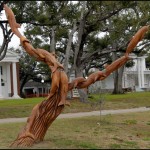 Dayton Scoggins carves dolphins from the dead trees