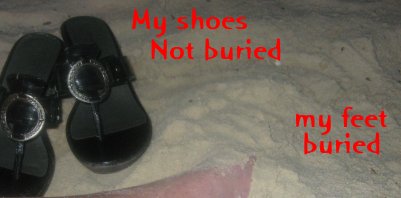 My feet buried on the beach