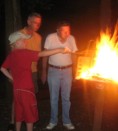 PawPaw, the Droid, The Prince all roasting marshmallows on our camping trip